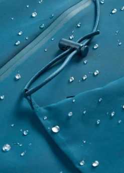 bonprix bonprix Chubasquero ligero con bolso estilo bandolera Petróleo azul Sale